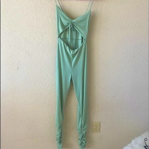 One piece stacked leg jumpsuit with mid cut out and spaghetti straps.